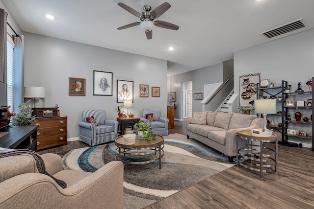 living room featuring ceiling fan and dark hardwood / wood-style floors