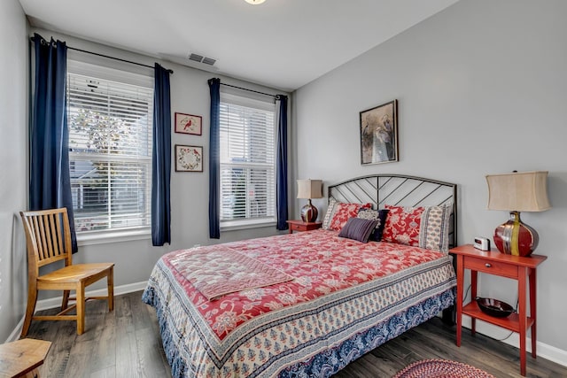 bedroom with dark wood-type flooring