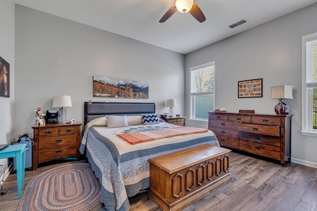 bedroom with hardwood / wood-style floors and ceiling fan