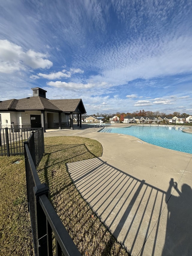 view of swimming pool with a lawn and a patio area