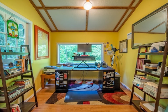 office featuring lofted ceiling and hardwood / wood-style flooring