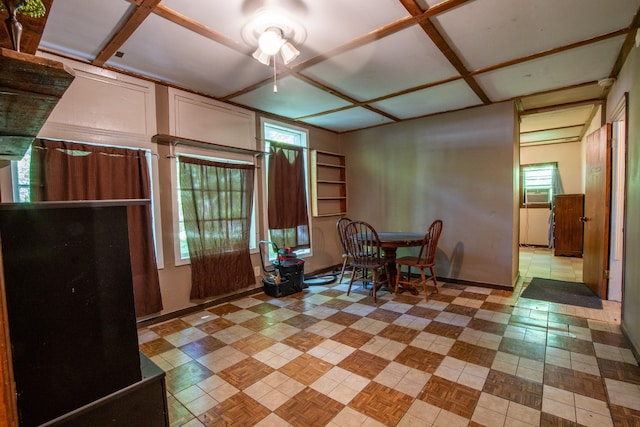 dining space featuring coffered ceiling and ceiling fan