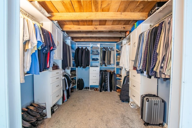 walk in closet with carpet flooring and beam ceiling