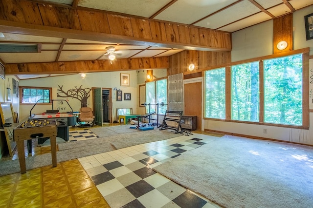 game room with wooden walls and lofted ceiling with beams