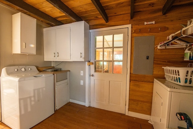 washroom featuring electric panel, independent washer and dryer, cabinets, wooden ceiling, and wood walls