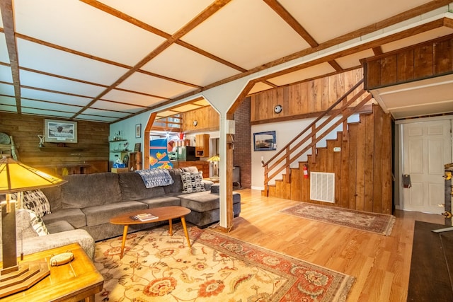 living room with hardwood / wood-style floors and wood walls