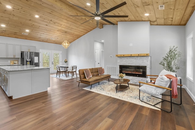 living room featuring dark wood-type flooring, french doors, high vaulted ceiling, wooden ceiling, and ceiling fan