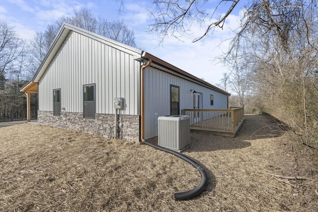 view of home's exterior with a wooden deck and central air condition unit