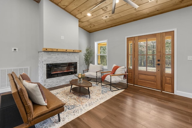 living room featuring hardwood / wood-style flooring, lofted ceiling, and wood ceiling