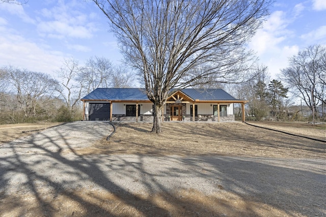 ranch-style home featuring a porch and a garage