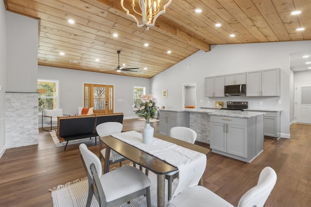 dining area with ceiling fan with notable chandelier, dark hardwood / wood-style floors, lofted ceiling with beams, and wooden ceiling