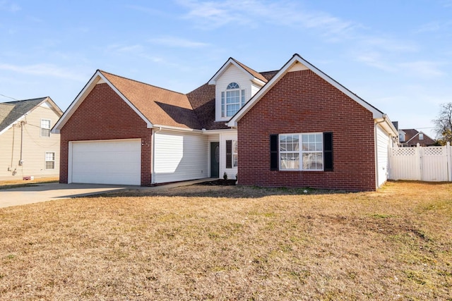 view of property featuring a garage and a front lawn