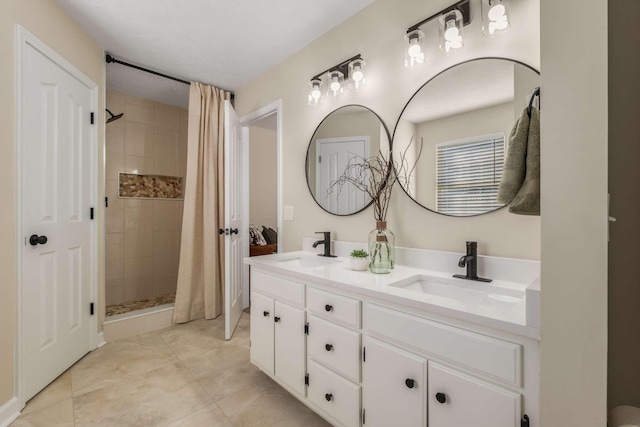 bathroom with a shower with curtain, vanity, and tile patterned flooring