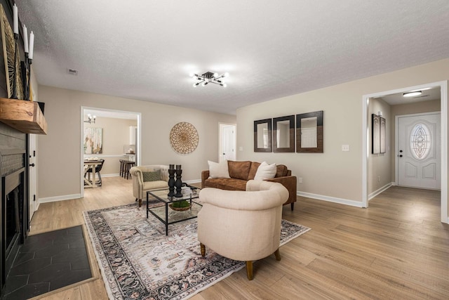 living room featuring a textured ceiling and light hardwood / wood-style floors