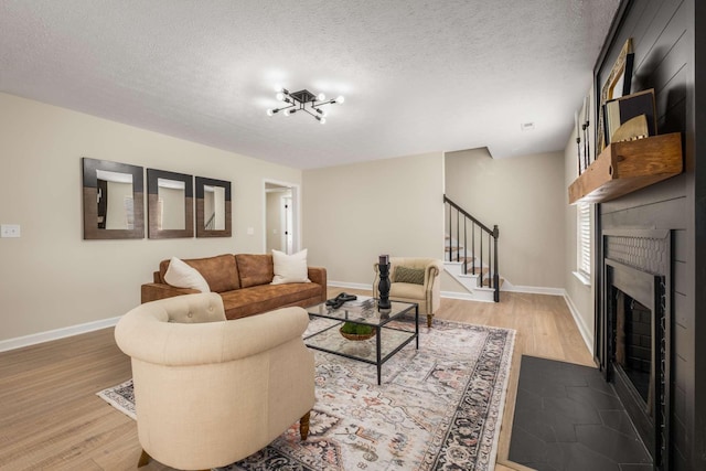 living room with hardwood / wood-style flooring and a textured ceiling