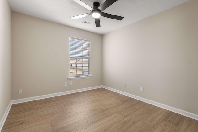 empty room featuring ceiling fan and light hardwood / wood-style floors