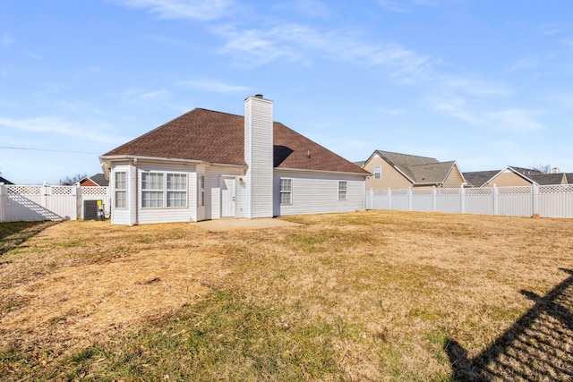 rear view of property featuring a yard