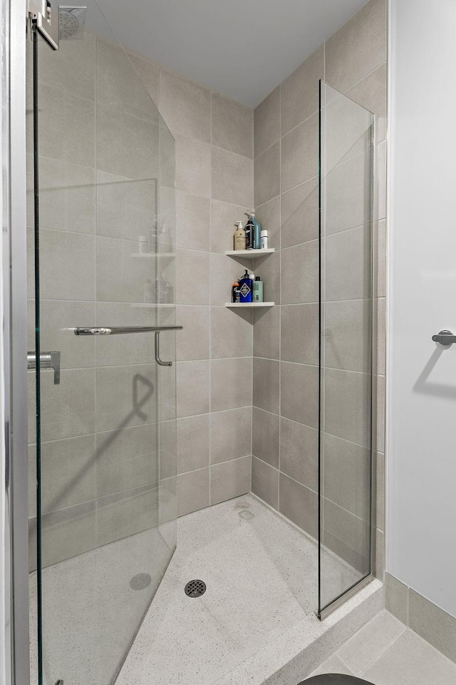 bathroom featuring a shower with shower door