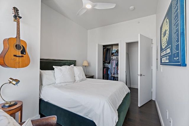 bedroom with dark wood-type flooring, ceiling fan, and a closet