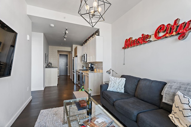 living room featuring dark hardwood / wood-style floors and a chandelier