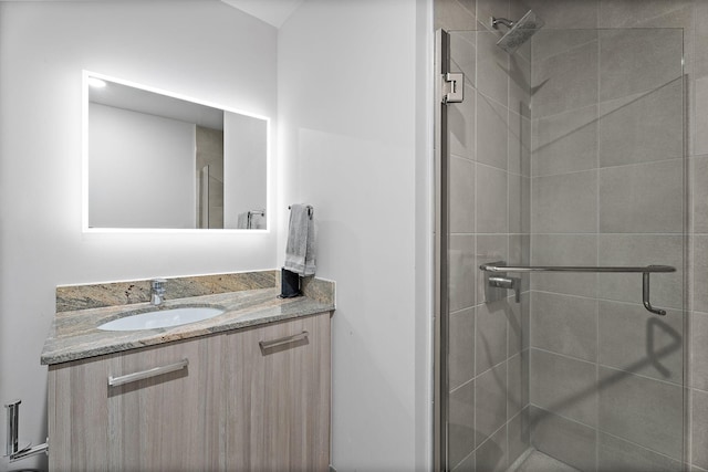 bathroom featuring vanity and a shower with door