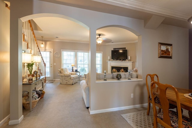 living room with crown molding and light colored carpet