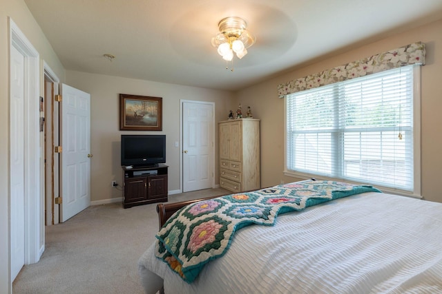bedroom featuring light carpet