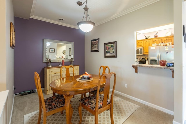 dining area featuring crown molding and light carpet