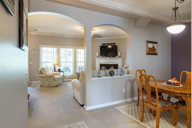 carpeted dining space featuring ornamental molding