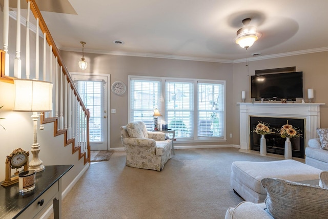 carpeted living room featuring crown molding and a wealth of natural light
