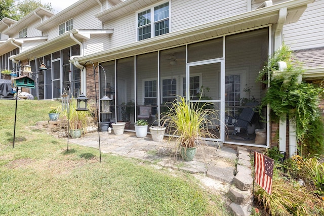 back of house featuring a sunroom and a yard