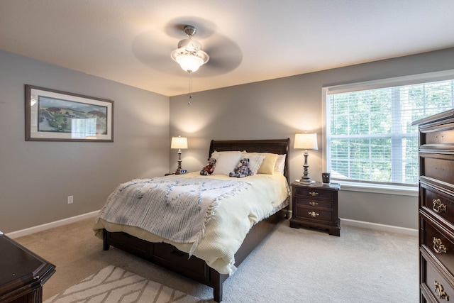 bedroom with light colored carpet and ceiling fan