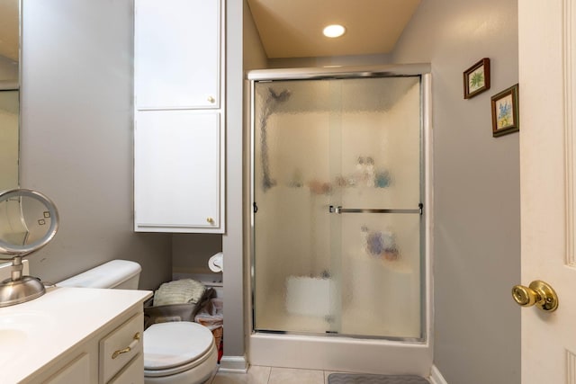 bathroom featuring an enclosed shower, vanity, tile patterned floors, and toilet