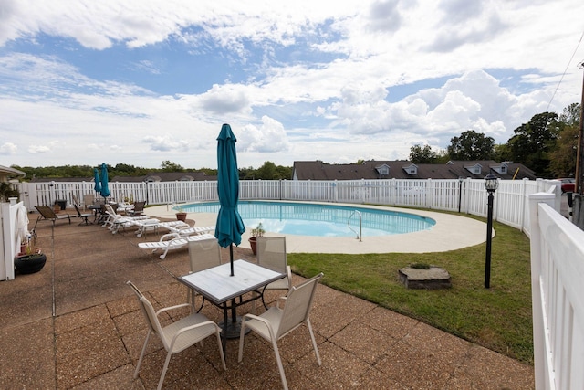 view of swimming pool with a patio