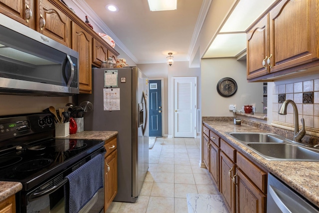 kitchen featuring sink, light tile patterned floors, ornamental molding, appliances with stainless steel finishes, and backsplash