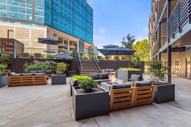 view of patio / terrace featuring an outdoor living space with a fire pit