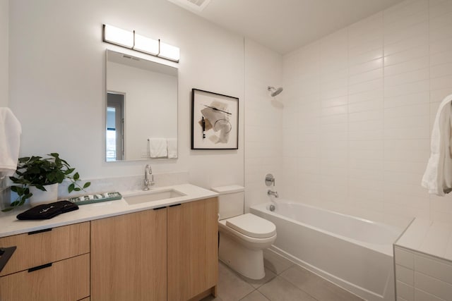 full bathroom featuring vanity, tiled shower / bath combo, tile patterned floors, and toilet