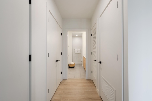 corridor with light hardwood / wood-style floors