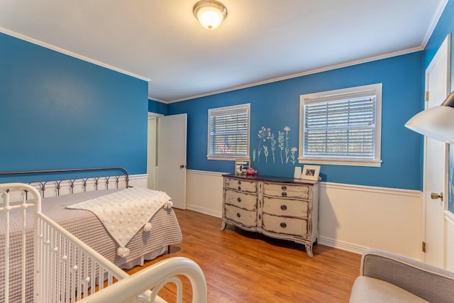 bedroom featuring ornamental molding and light wood-type flooring