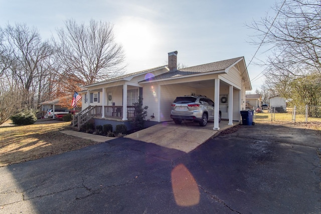 view of front of house featuring a carport and covered porch