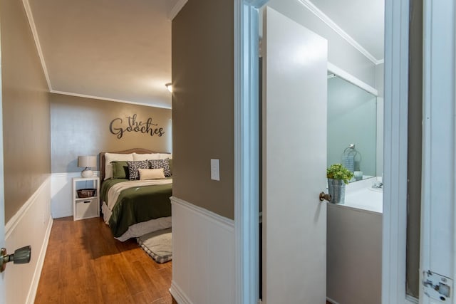 bedroom featuring hardwood / wood-style flooring and ornamental molding