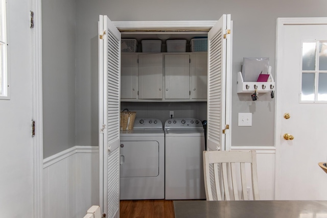 laundry room with cabinets, dark hardwood / wood-style floors, and washer and clothes dryer