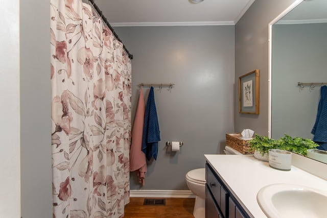 bathroom with ornamental molding, toilet, hardwood / wood-style floors, and vanity