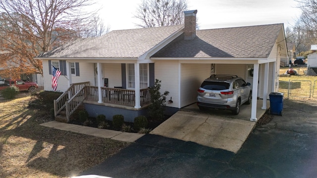 ranch-style home featuring a carport and covered porch