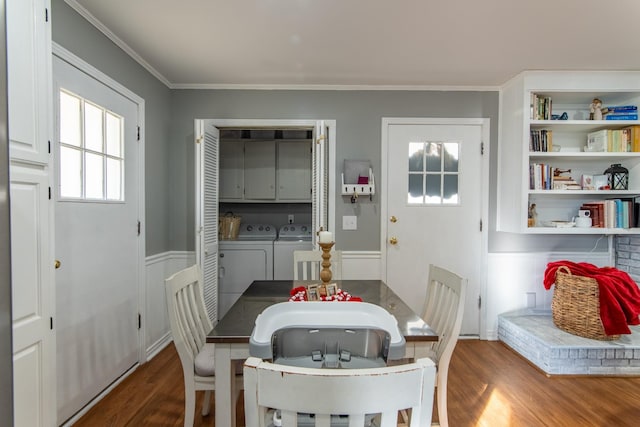 dining space with washing machine and dryer, ornamental molding, built in features, and dark hardwood / wood-style flooring