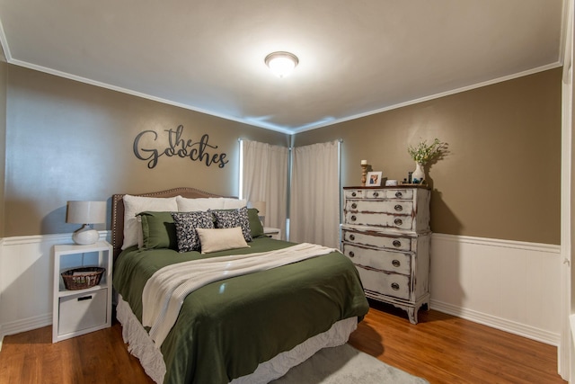 bedroom with hardwood / wood-style flooring and ornamental molding