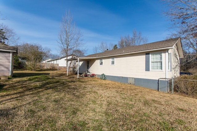 rear view of house with a yard