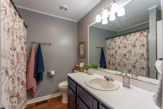 bathroom featuring vanity, wood-type flooring, ornamental molding, and toilet