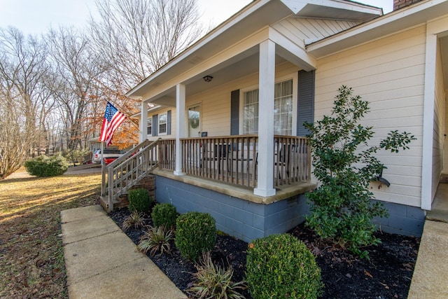 view of exterior entry with covered porch