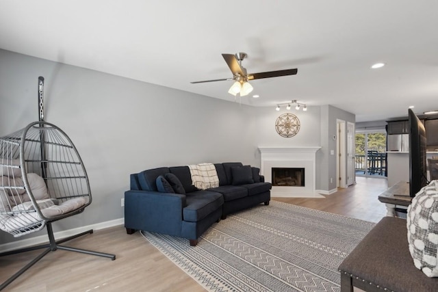 living room with hardwood / wood-style flooring and ceiling fan